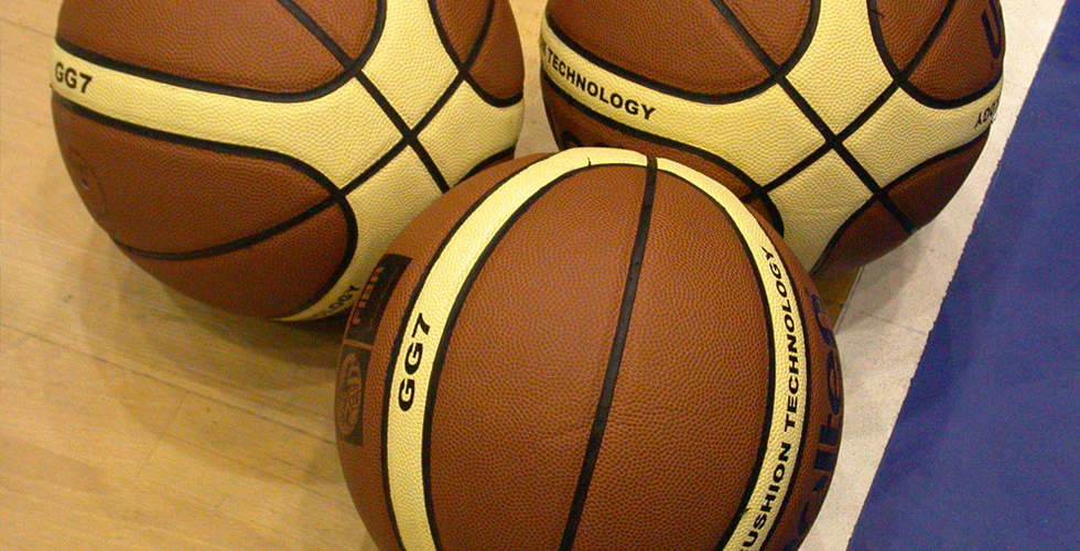 Closeup of three basketballs. 
