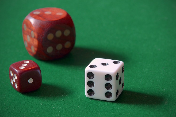 Three dice on gaming table. 