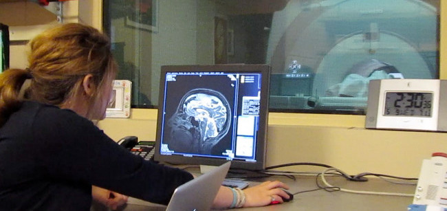 Woman sitting at computer in lab. 