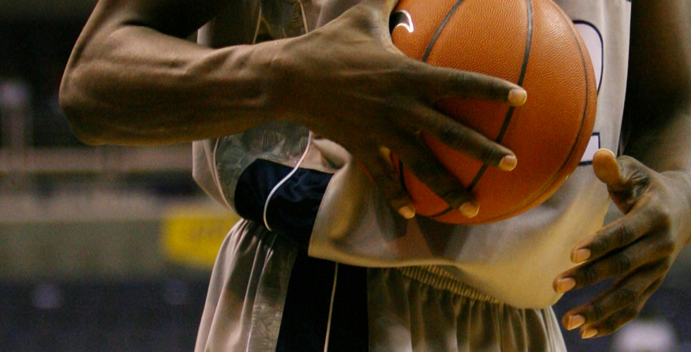Player carries a basketball.