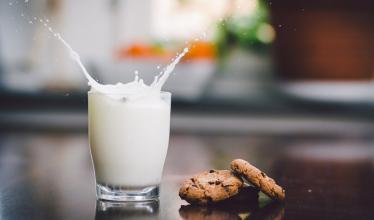 A glass of milk with cookies