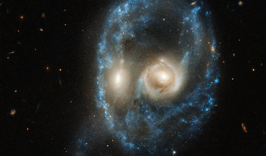 two galaxies, colliding in a pattern that resembles a spooky skeletal face