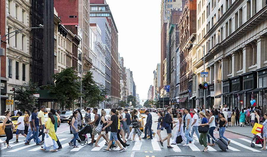 Crowded crosswalk in urban environment.