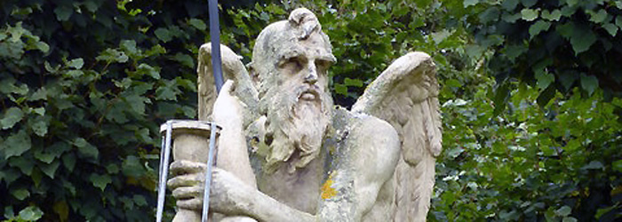 Father Time statue - old man with wings holding an hour glass.