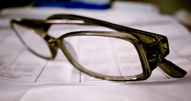 Reading glasses atop a printed page.