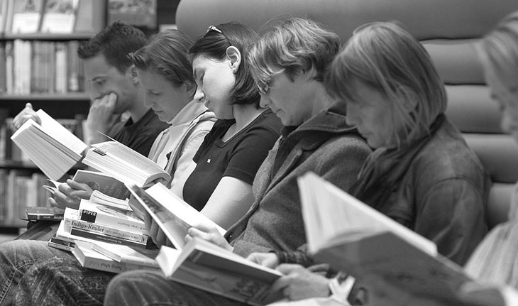 A group of people reading, 
