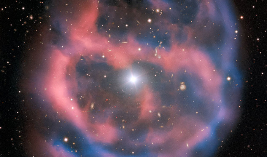 The planetary nebula ESO 577-24, captured in pale hues of pink and blue by ESO's Very Large Telescope.