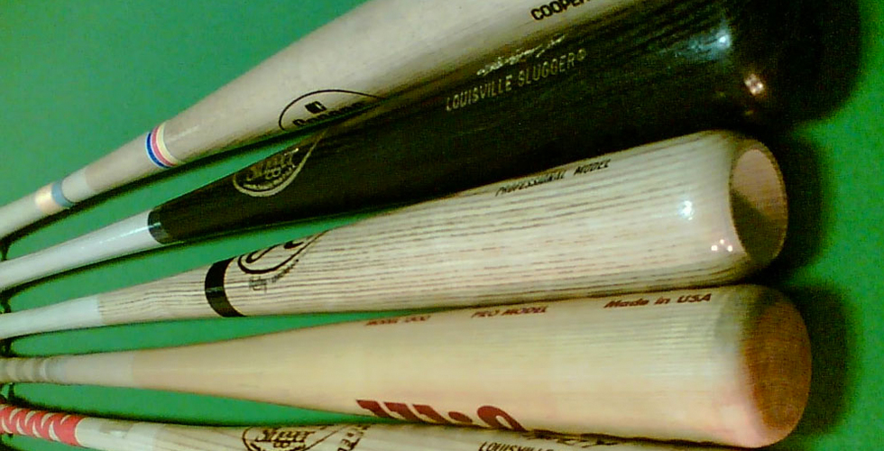 Five baseball bats arranged in a fan. 