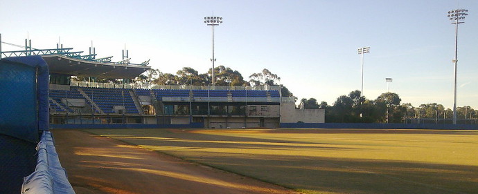 Empty baseball stadium at dusk.