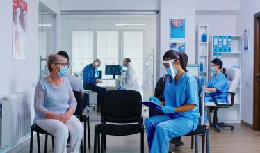 Medical office setting, with staff and patients in masks