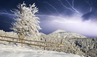 Lightning over a snowy landscape
